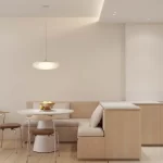 Thiết kế nội thất căn hộ với bếp mở liên thông bàn ăn và phòng khách tối giản.