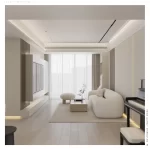 Thiết kế phòng khách căn hộ với sofa cong màu kem, hệ tủ TV và ánh sáng tự nhiên qua rèm cửa.